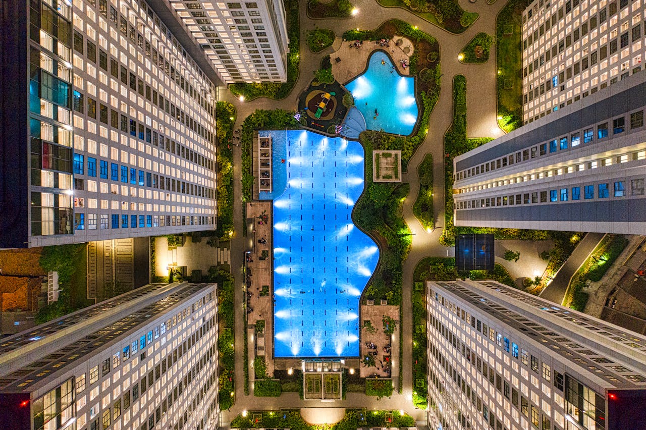 Captivating aerial shot of a modern urban complex in Banten, Indonesia, showcasing architecture and swimming pool at night.